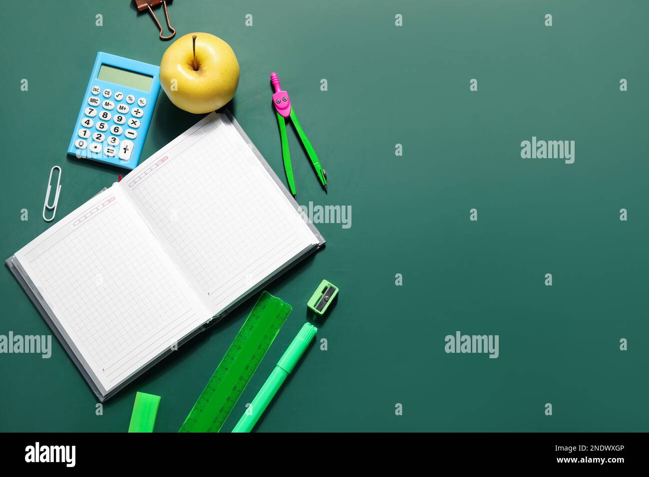 Set of stationery with blank open notebook on green blackboard. Pi Day celebration Stock Photo