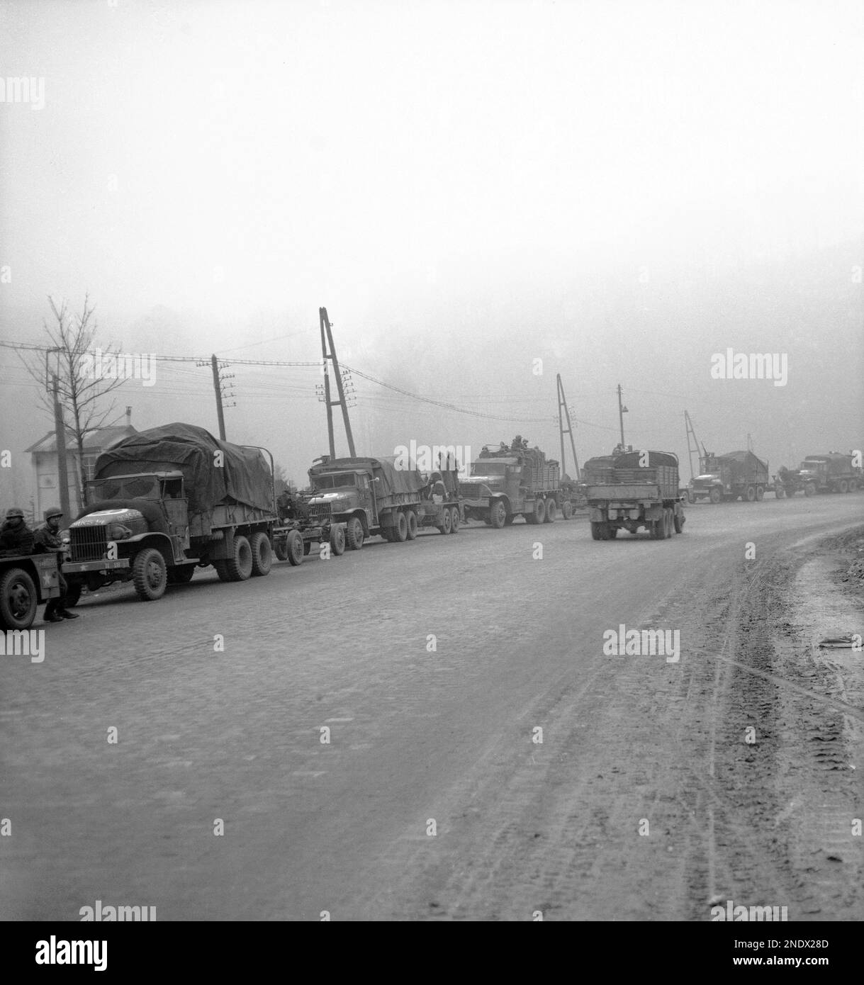 A long line of 40 mm. guns and Anti Aircraft guns pulling up in an ...