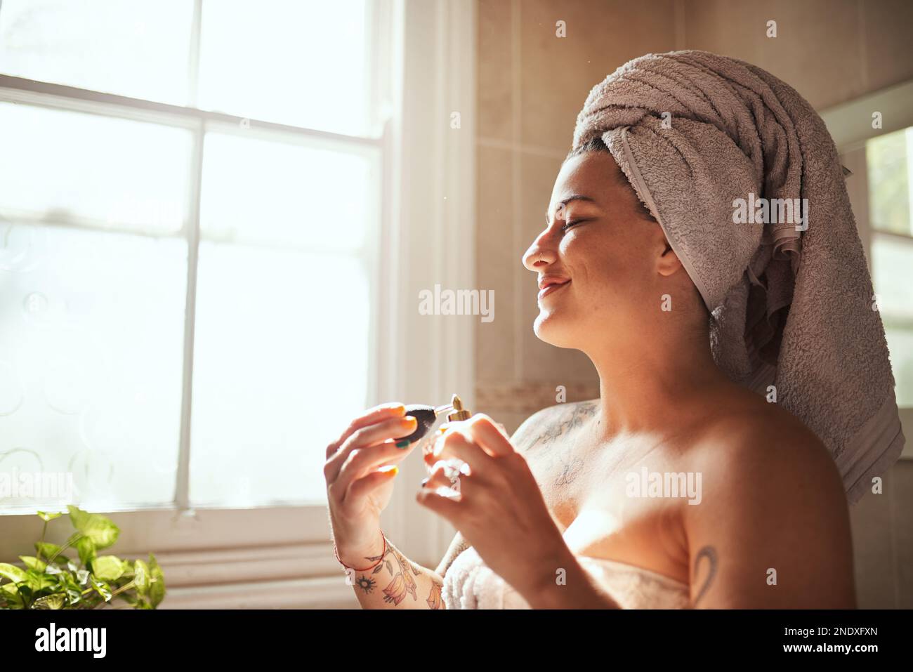 What does your scent say about you. a young woman spraying perfume
