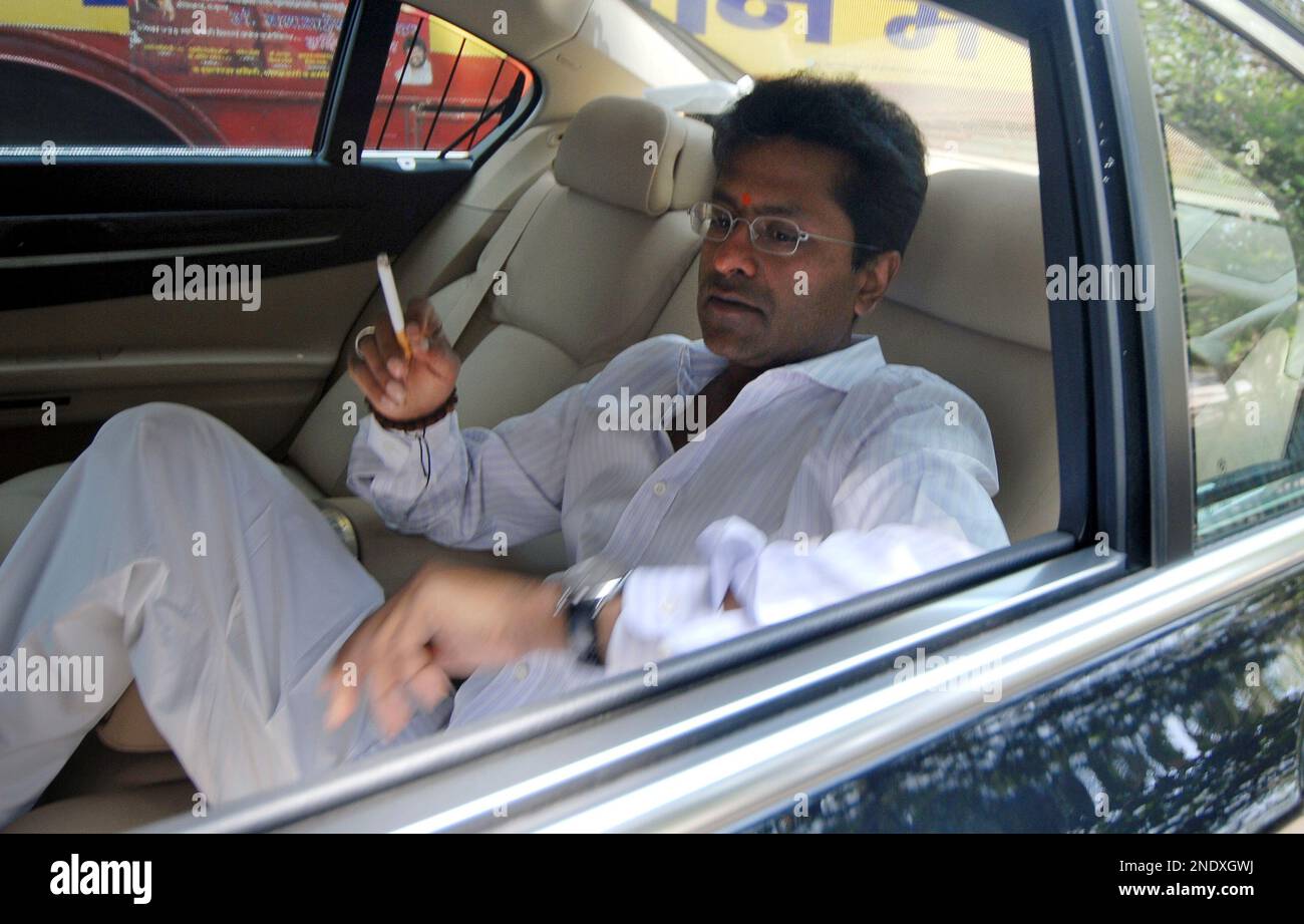 Indian Premier League chief Lalit Modi smokes a cigarette inside his car on  his way to meet Mukesh Ambani, a top industrialist and owner of the IPL  team Mumbai Indians, in Mumbai,