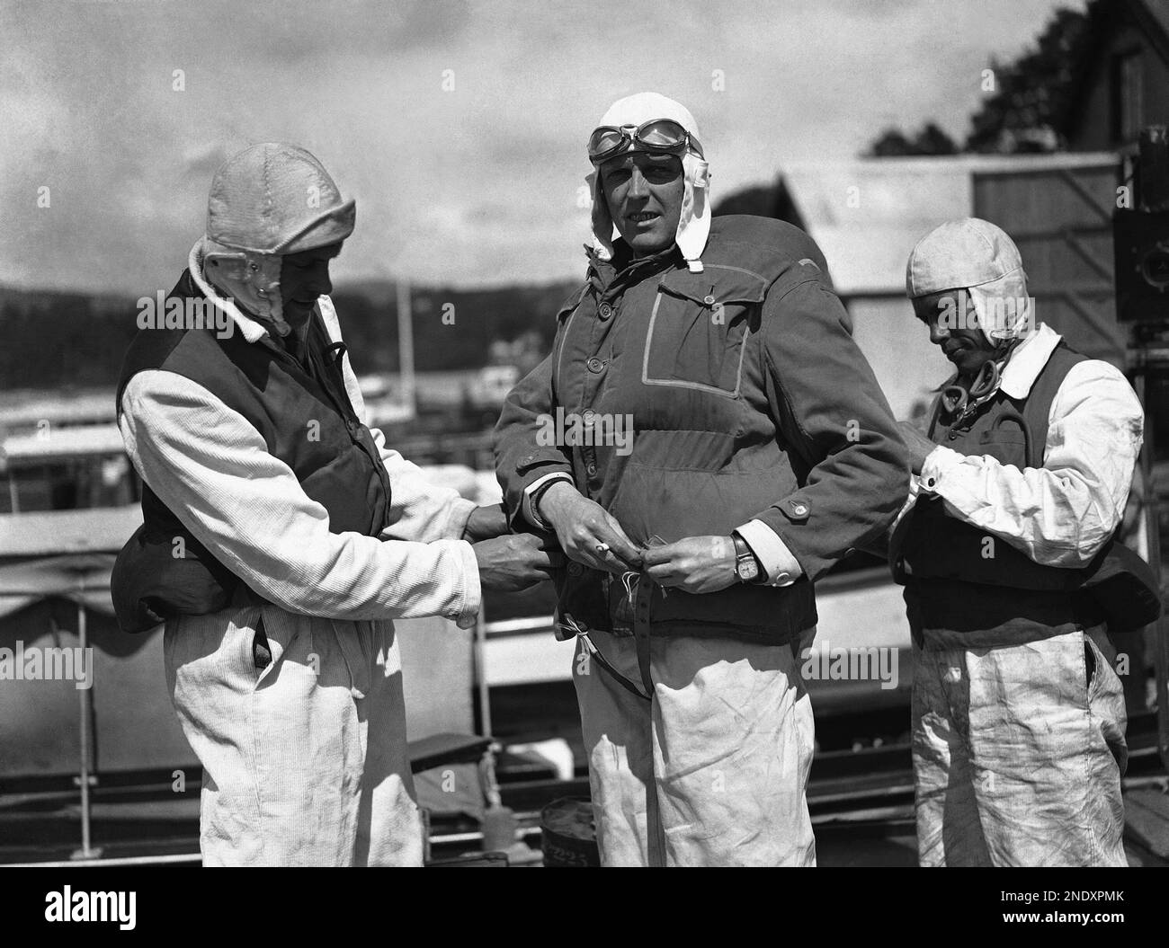 Sir Henry Segrave puts on steel lifebelt, to protect himself during a