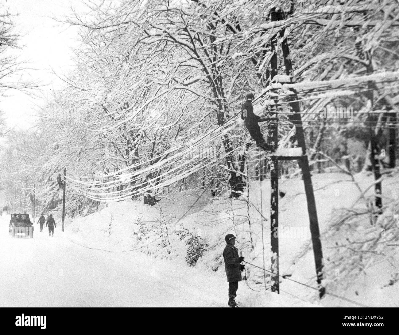 American linesmen of the first army string communication lines in a ...