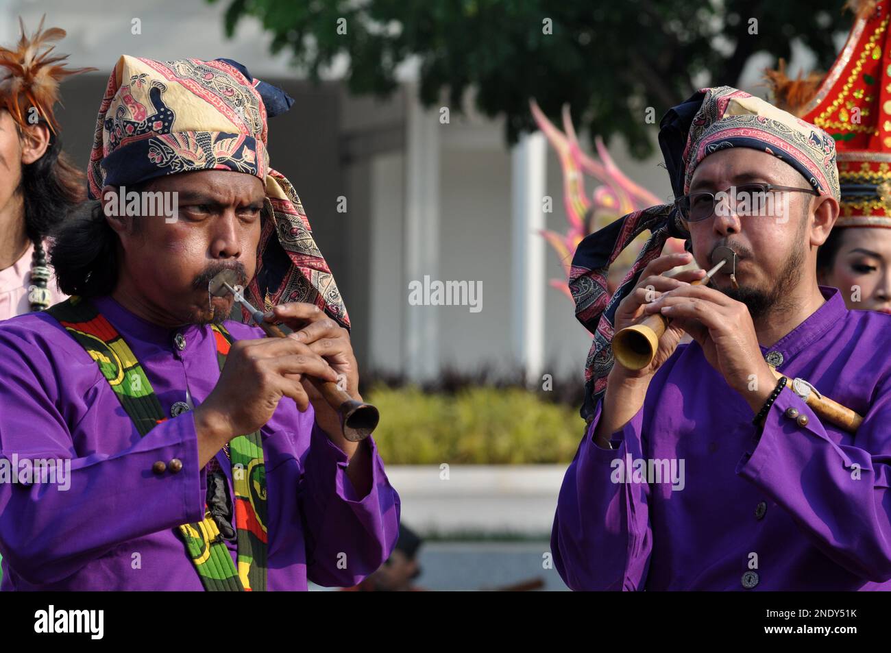 Jakarta, Indonesia - July 8, 2018 : Two musicians are playing the Pui Pui musical instrument, a traditional musical instrument from South Sulawesi, In Stock Photo