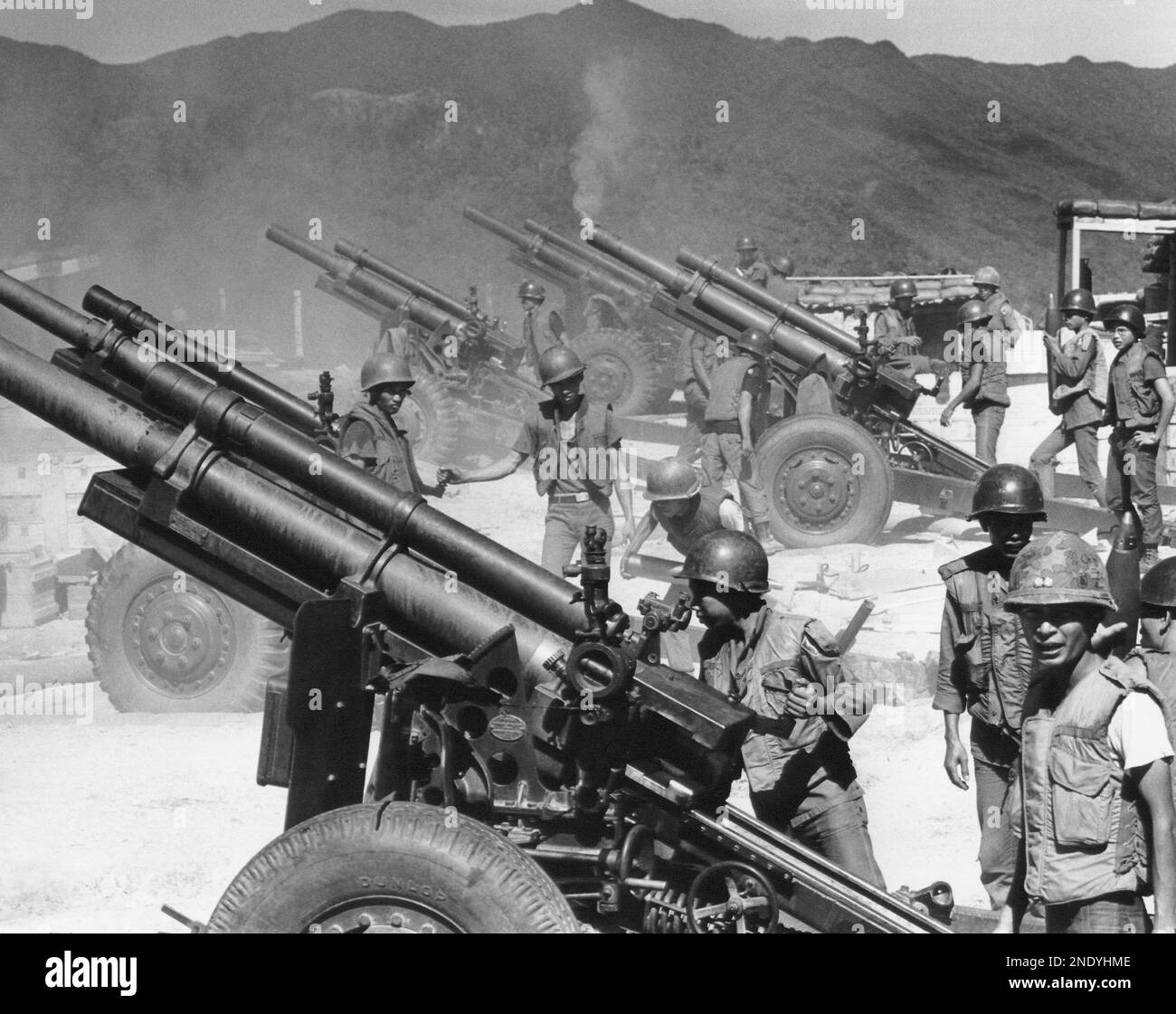 Five 105mm howitzers atop a flattened mountaintop in Vietnam called Firebase O'Reilly are fired in response to North Vietnamese mortar and recoilless rifle on August 18, 1970. (AP Photo/Mark Godfrey