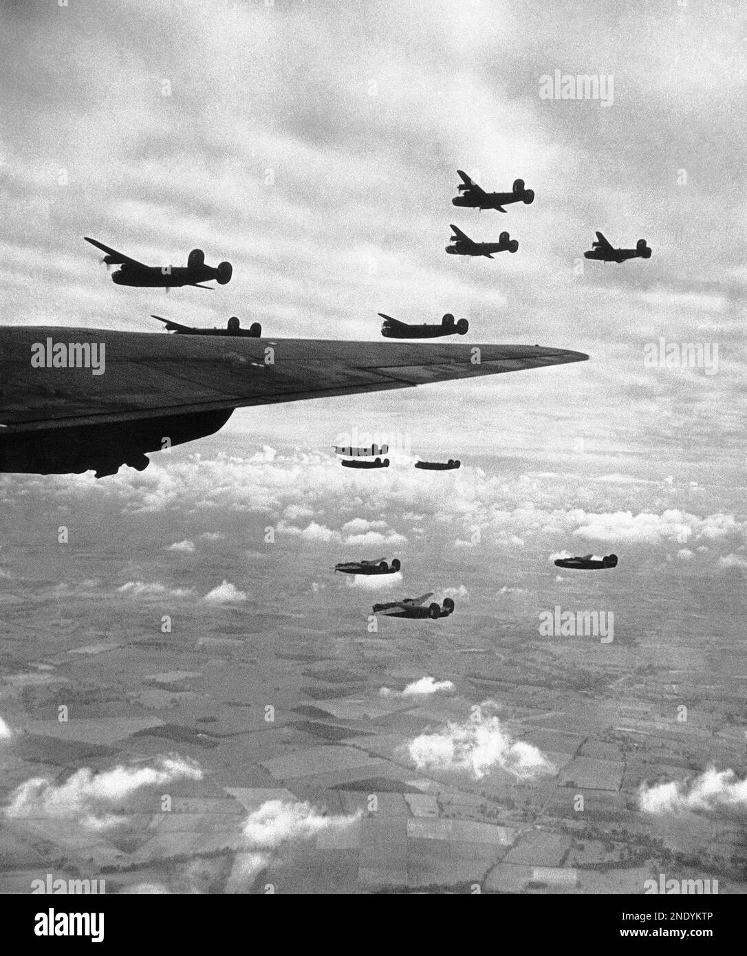 Giant Liberator bomberss flying in formation over England during a practice mission on July 7