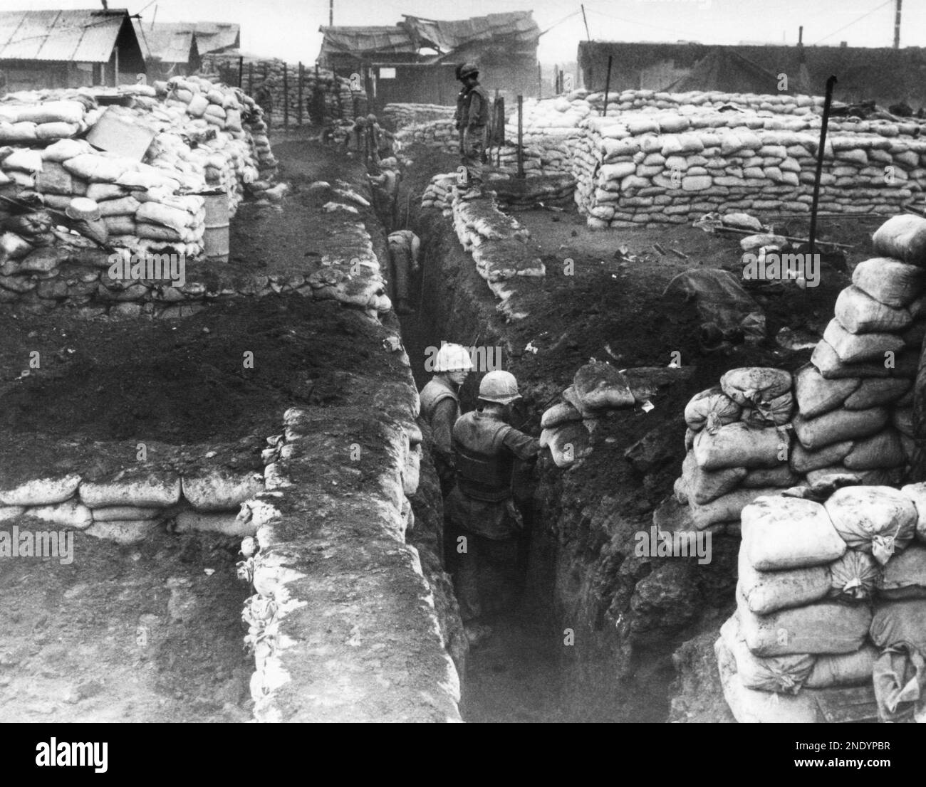 U.S. Marines at Khe Sanh, South Vietnam, dig deep trenches and fortify ...