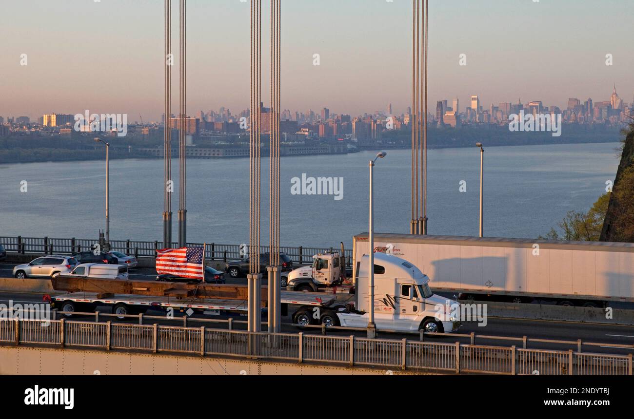 A steel beam salvaged from the World Trade Center is transported across
