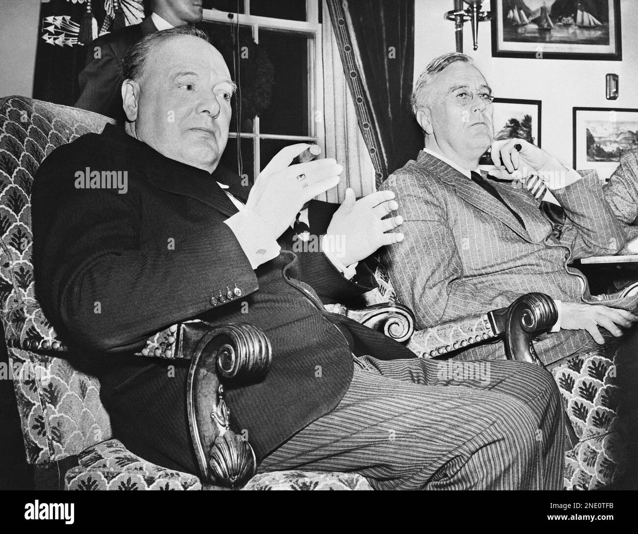 Prime Minister Winston Churchill, left, of Great Britain and President Franklin Roosevelt faced reporters at the White House in Washington on Dec. 23, 1941 at a press conference in which the heads of two great world powers linked in a common war expresses confidence in victory. Churchill, with his customary black cigar, emphasizes his reply to a question with a gesture. (AP Photo) Stock Photo