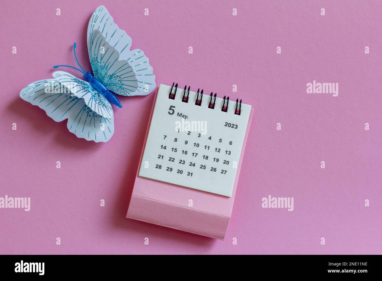 calendar-for-may-2023-on-a-pink-background-with-butterflies-stock-photo