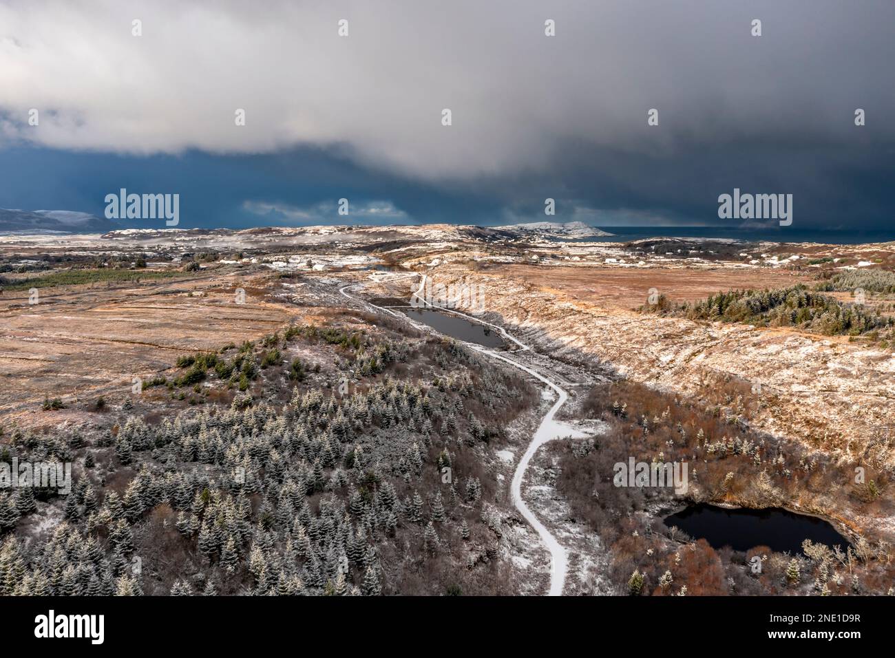 Aerial view of snow covered Bonny Glen Woods by Portnoo in County Donegal, Ireland Stock Photo