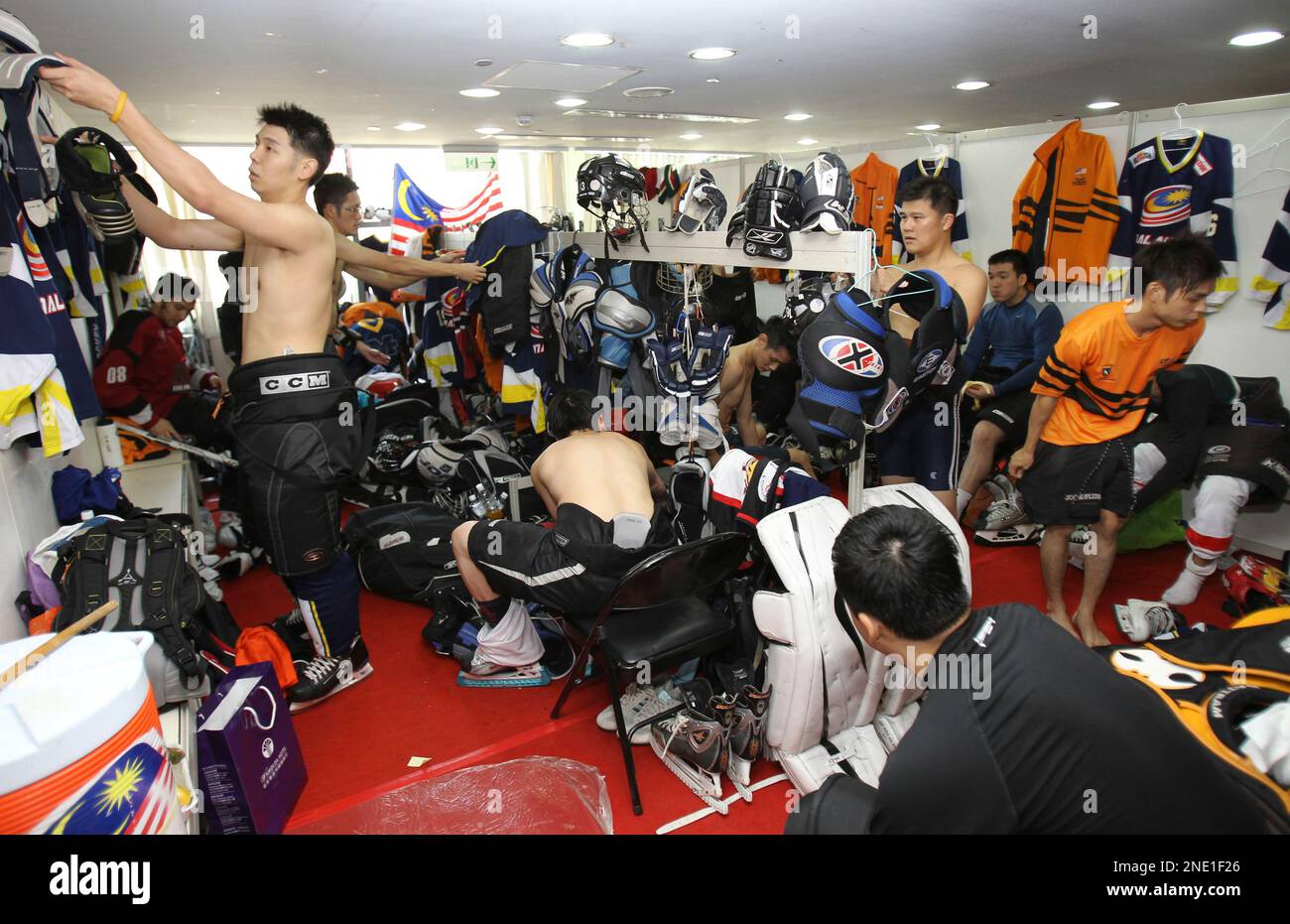 Malaysia's national hockey players changes in a locker room after a