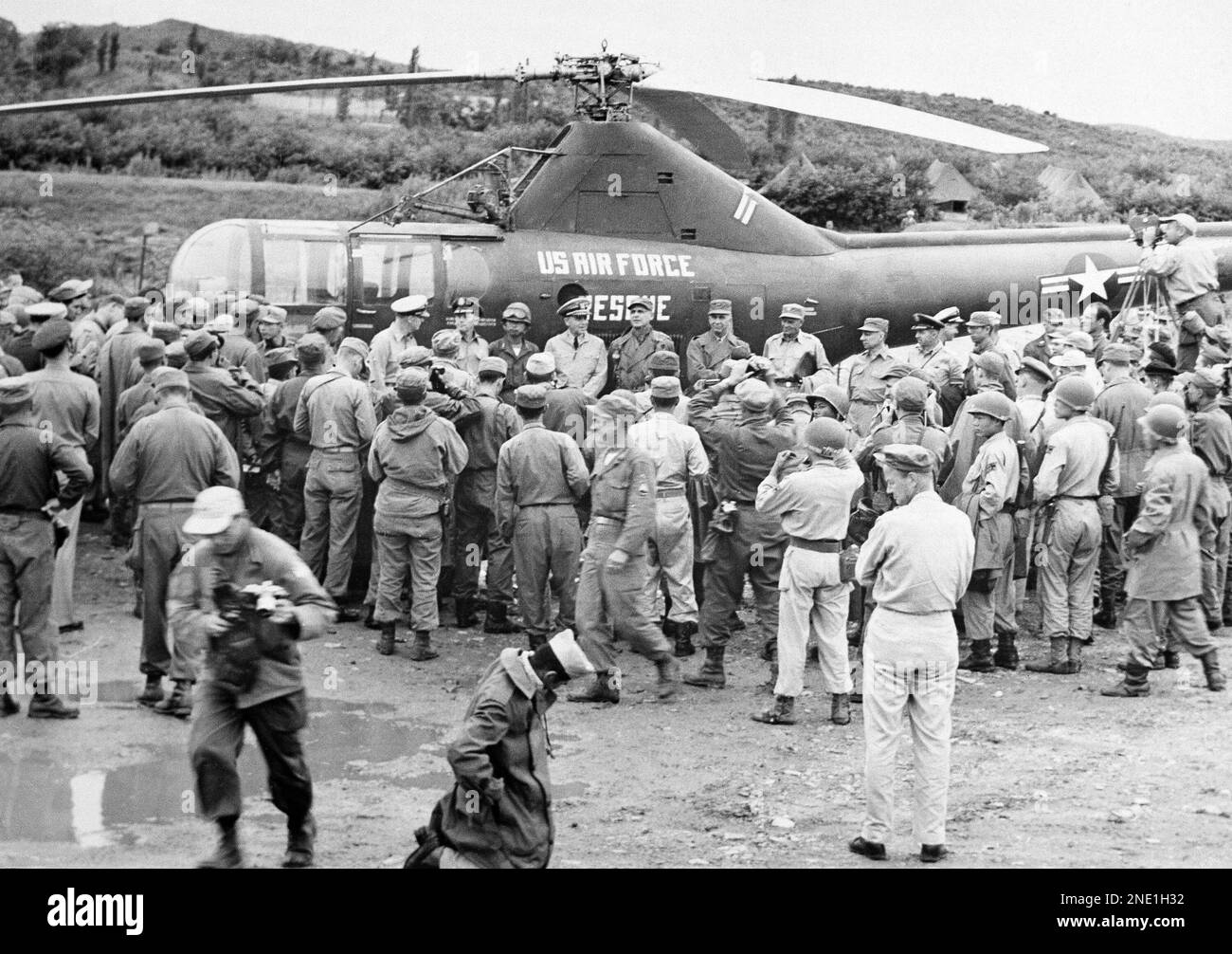 U.N. peace negotiators pose beside their helicopter with Gen. Matthew B ...