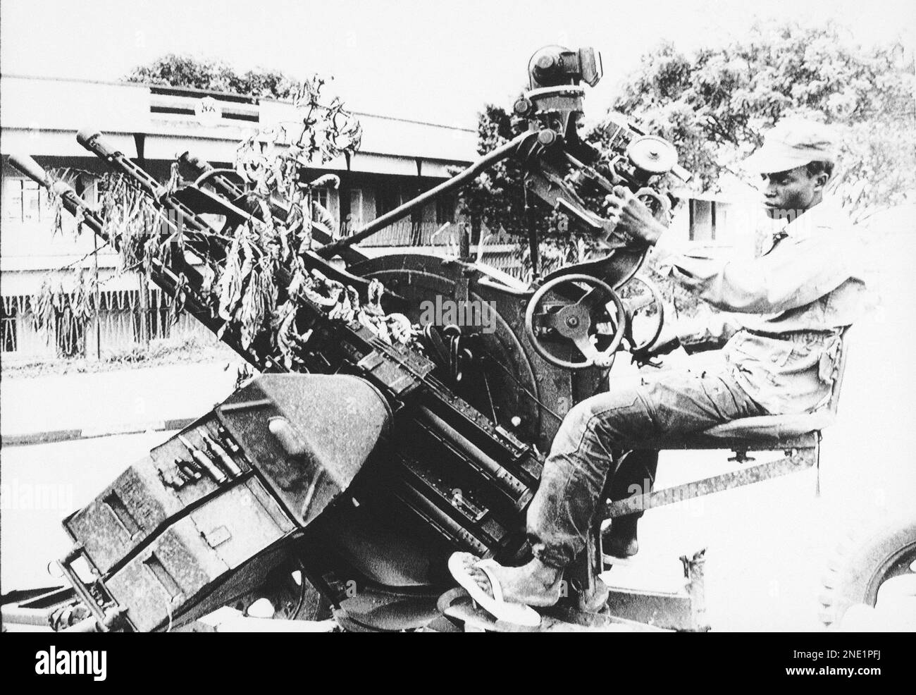A Ugandan soldier mans an anti-aircraft gun set up in a Kampala street ...