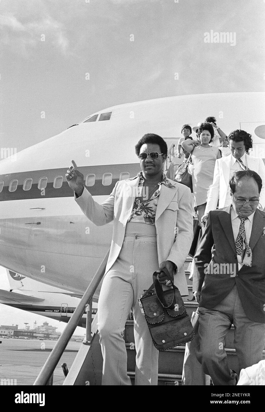 Foreman, World Heavyweight boxing champion, steps from a jet at