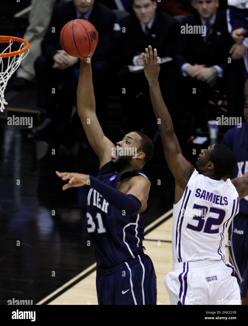 Xavier's Jason Love (31) shoots around the defense of Kansas State's