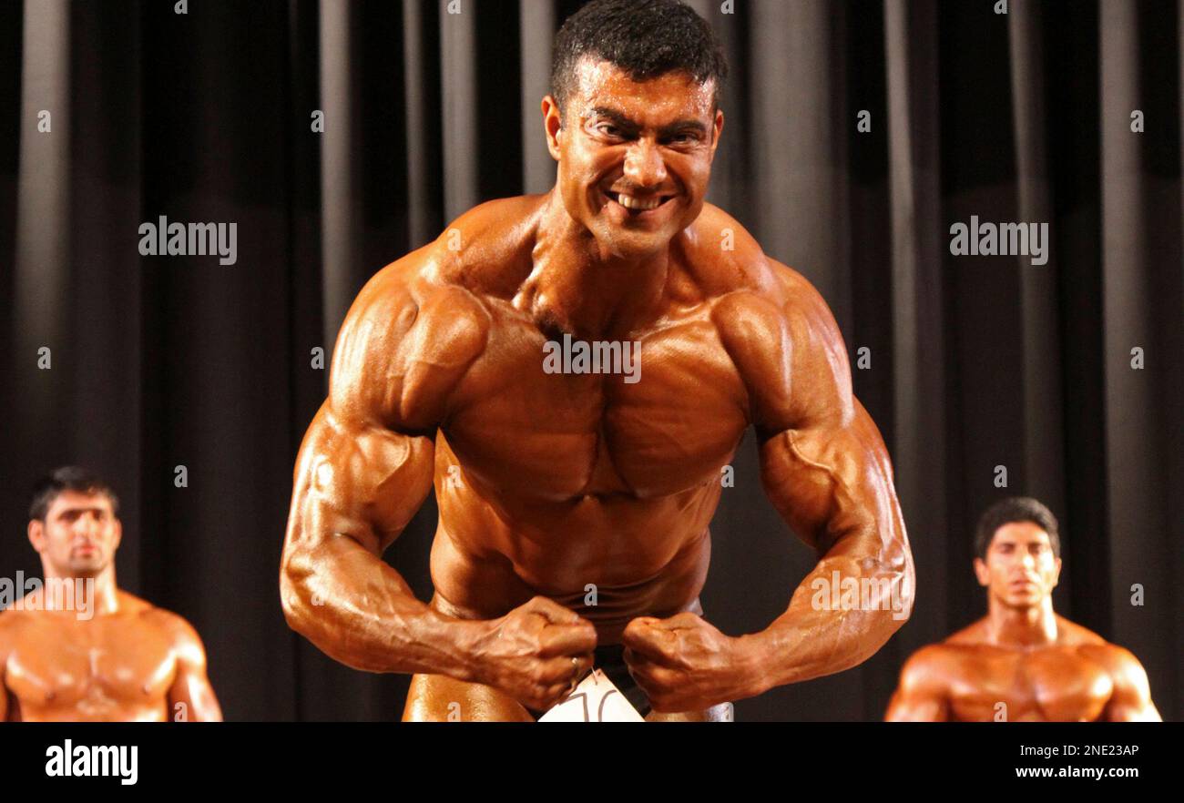 Contestants display their muscles during a state level body building