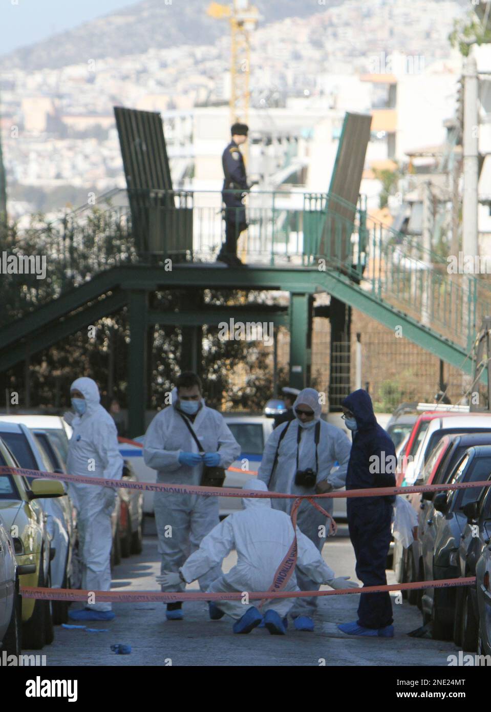 Members of the Greek anti-terrorist team investigate an area after an ...