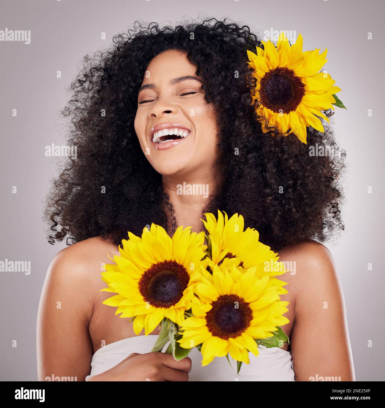 Portrait, cheerful or face of black woman with sunflower in hair in ...