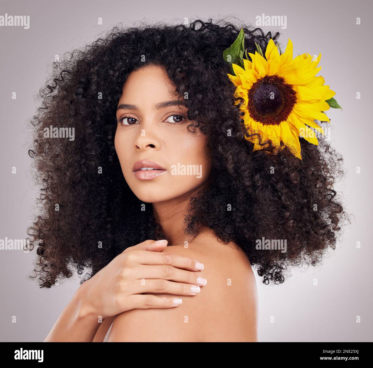 Portrait, serious or face of black woman with sunflower in hair in ...