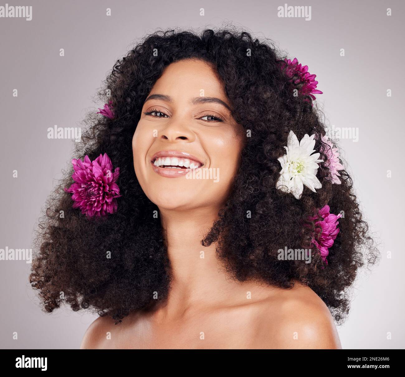 Portrait, smile or face of black woman with flowers in hair in studio ...