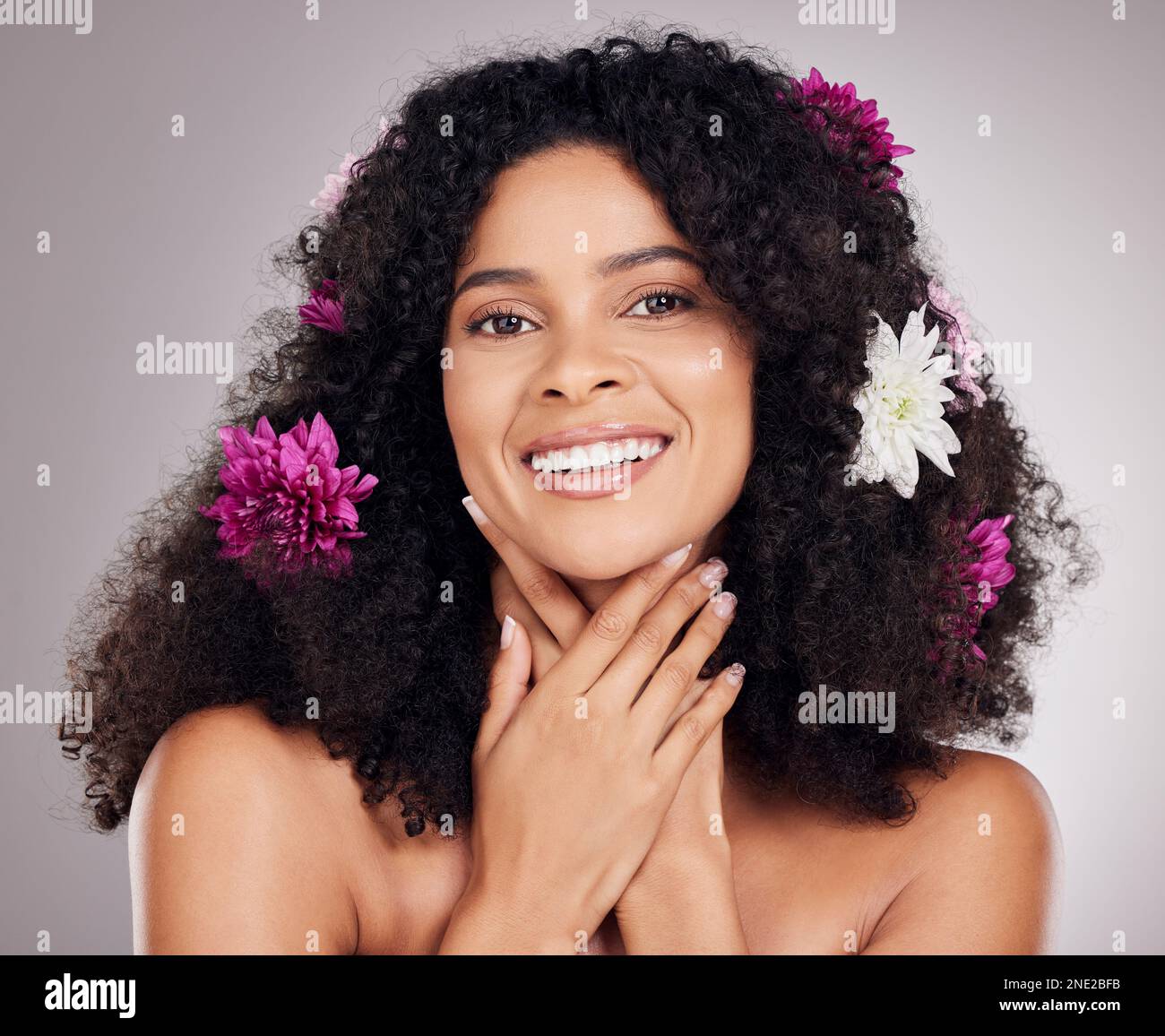 Skincare, smile or face of black woman with flowers in hair for spring ...