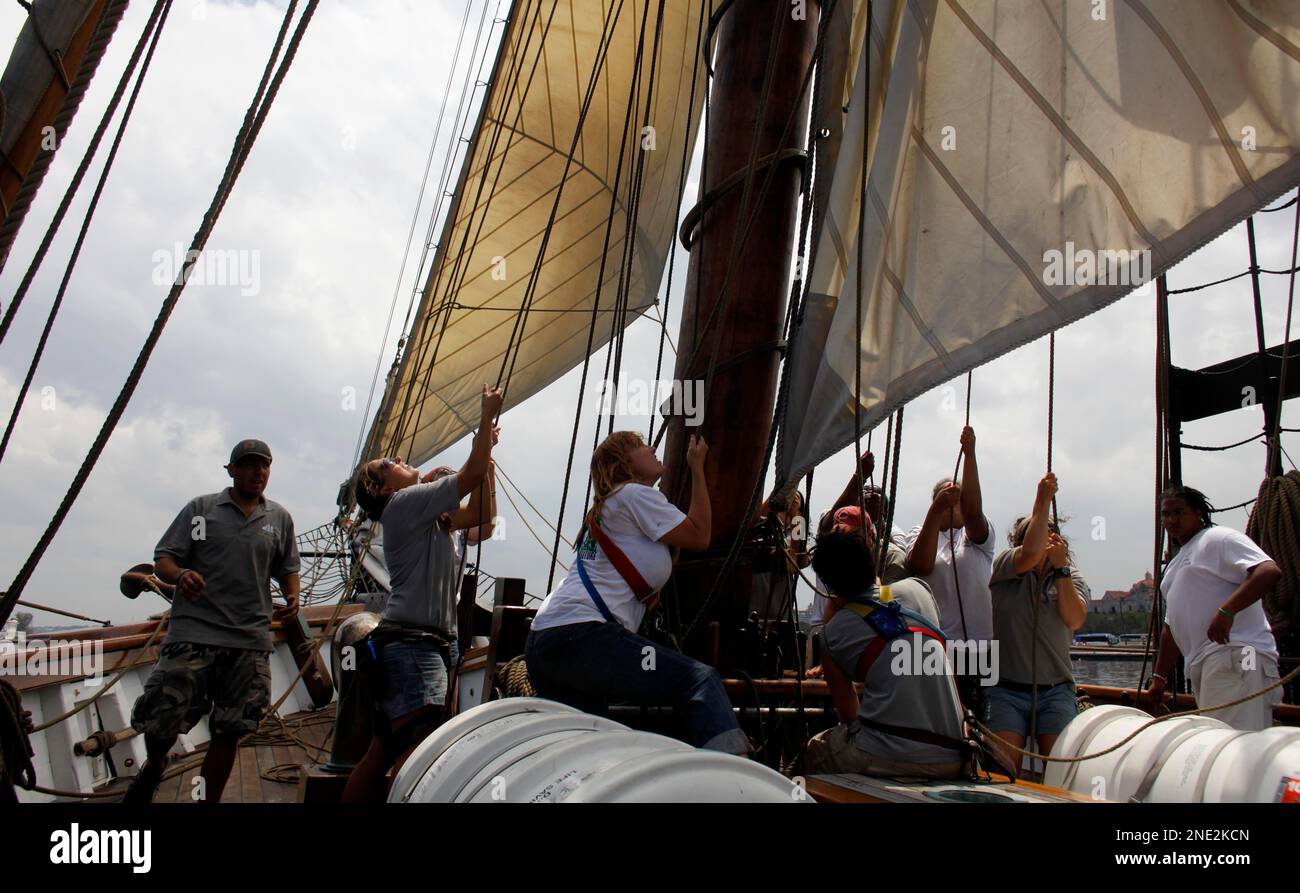 Members of U.S.flagged vessel Amistad crew lower the sails as they