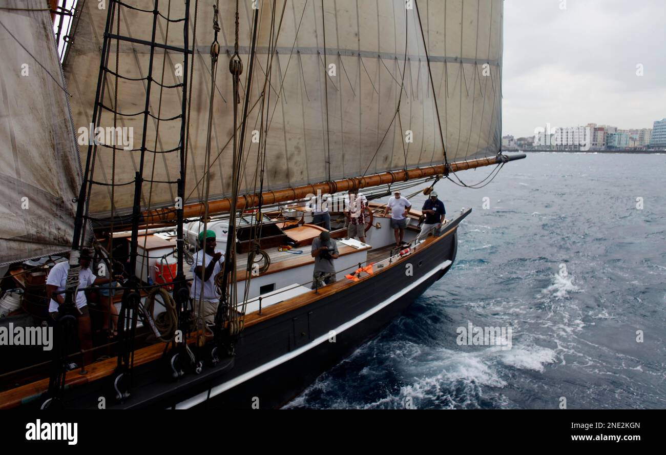 Members of U.S.flagged vessel Amistad crew work as it arrives at the