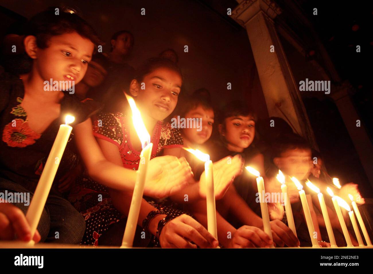 Bangladeshi children light candles in remembrance of their country's independence war heroes, in Dhaka, Bangladesh, Thursday, March 25, 2010. Bangladesh will celebrate its 39th Independence Day Friday. (AP Photo/Pavel Rahman) Stock Photo