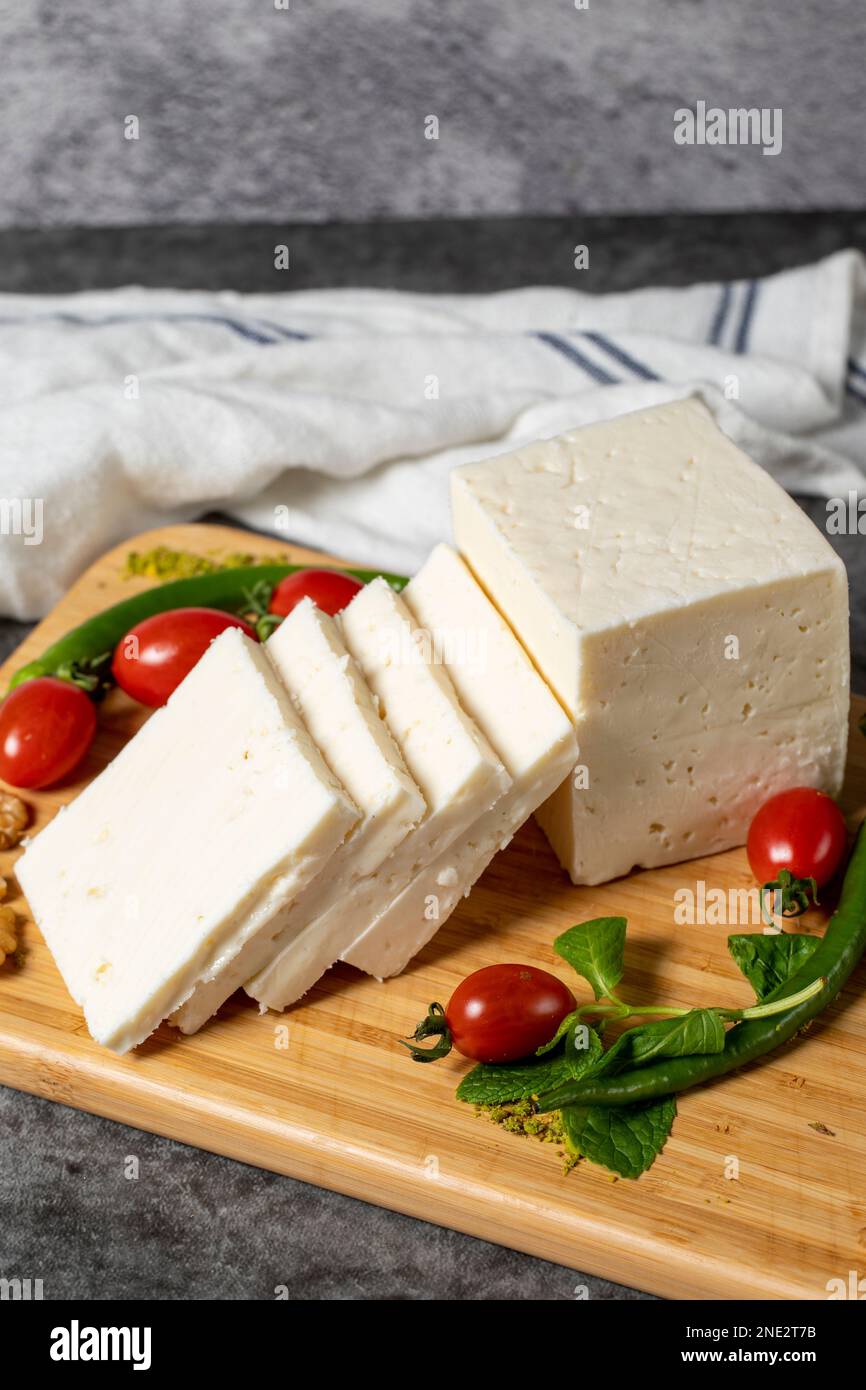 Ripe white cheese. Feta cheese made from cow's milk on a wooden serving