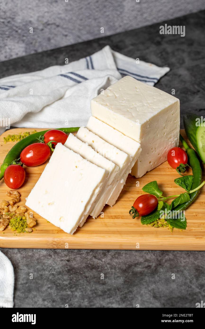 Ripe white cheese. Feta cheese made from cow's milk on a wooden serving