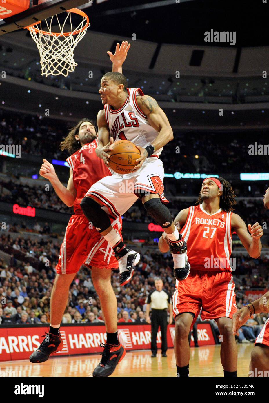 Chicago Bulls Derrick Rose 1 drives to the basket between Houston Rockets Luis Scola 4 and Jordan Hill 27 during the second half of an NBA basketball game Monday March 22 2010