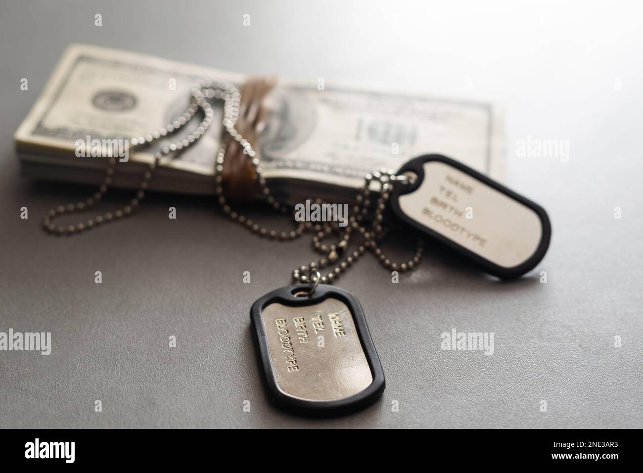 The soldier's military tokens are on dollar bills. Concept cost of