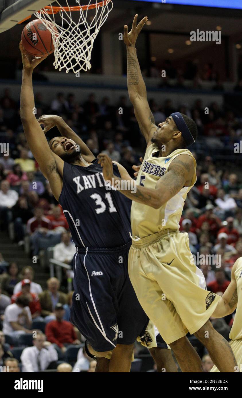 Xavier's Jason Love (31) is fouled as he shoots in front o Pittsburgh's