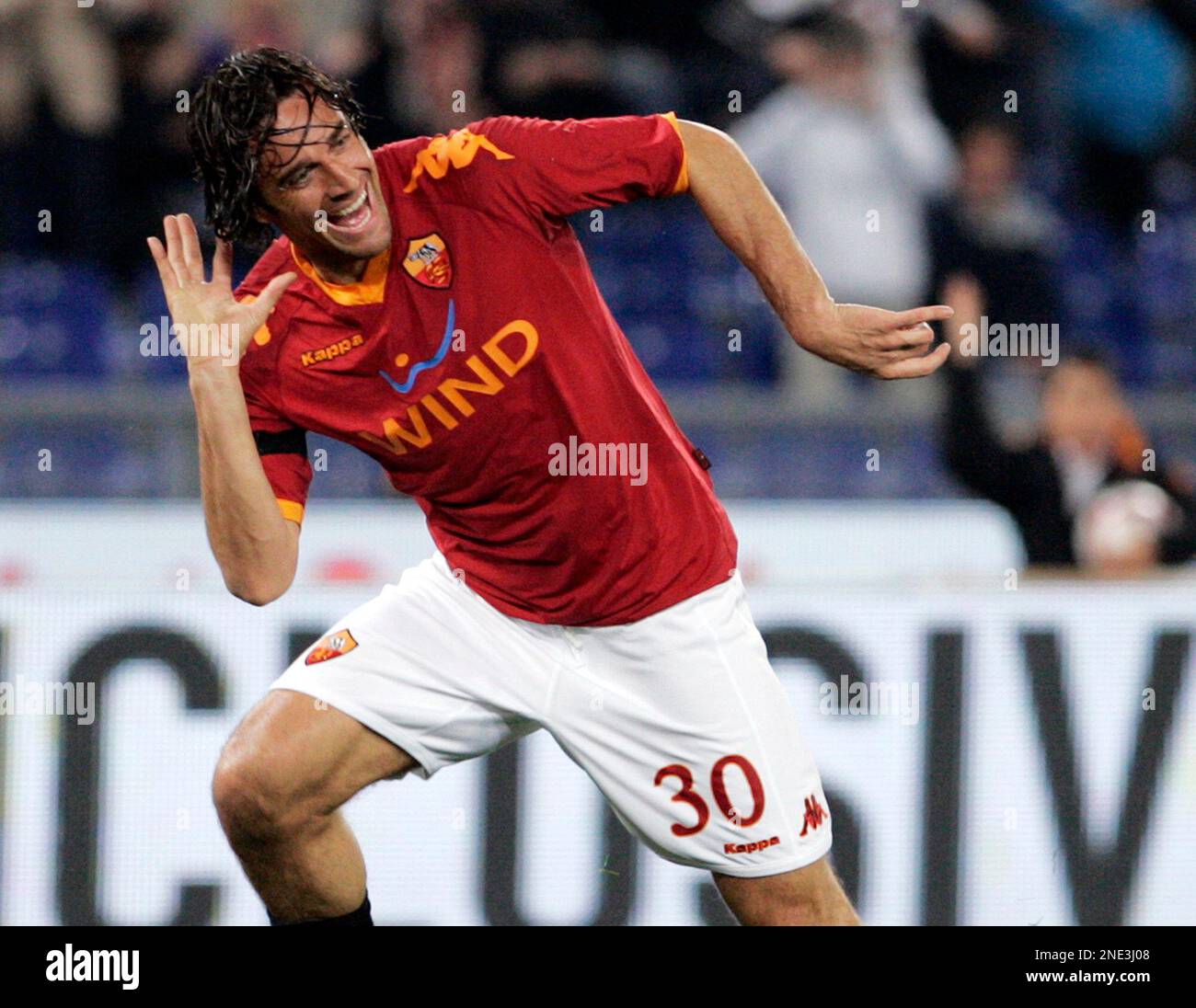 AS Roma forward Luca Toni celebrates past Udinese defender Giovanni  Pasquale, left, after scoring during a Serie A soccer match between AS Roma  and Udinese at Rome's Olympic stadium, Saturday, March 20,