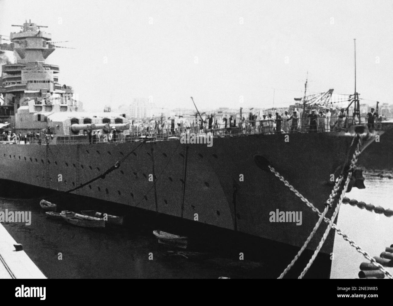 Image showcasing The 35,000-ton French battleship Jean Bart, tied up at moorings at ...