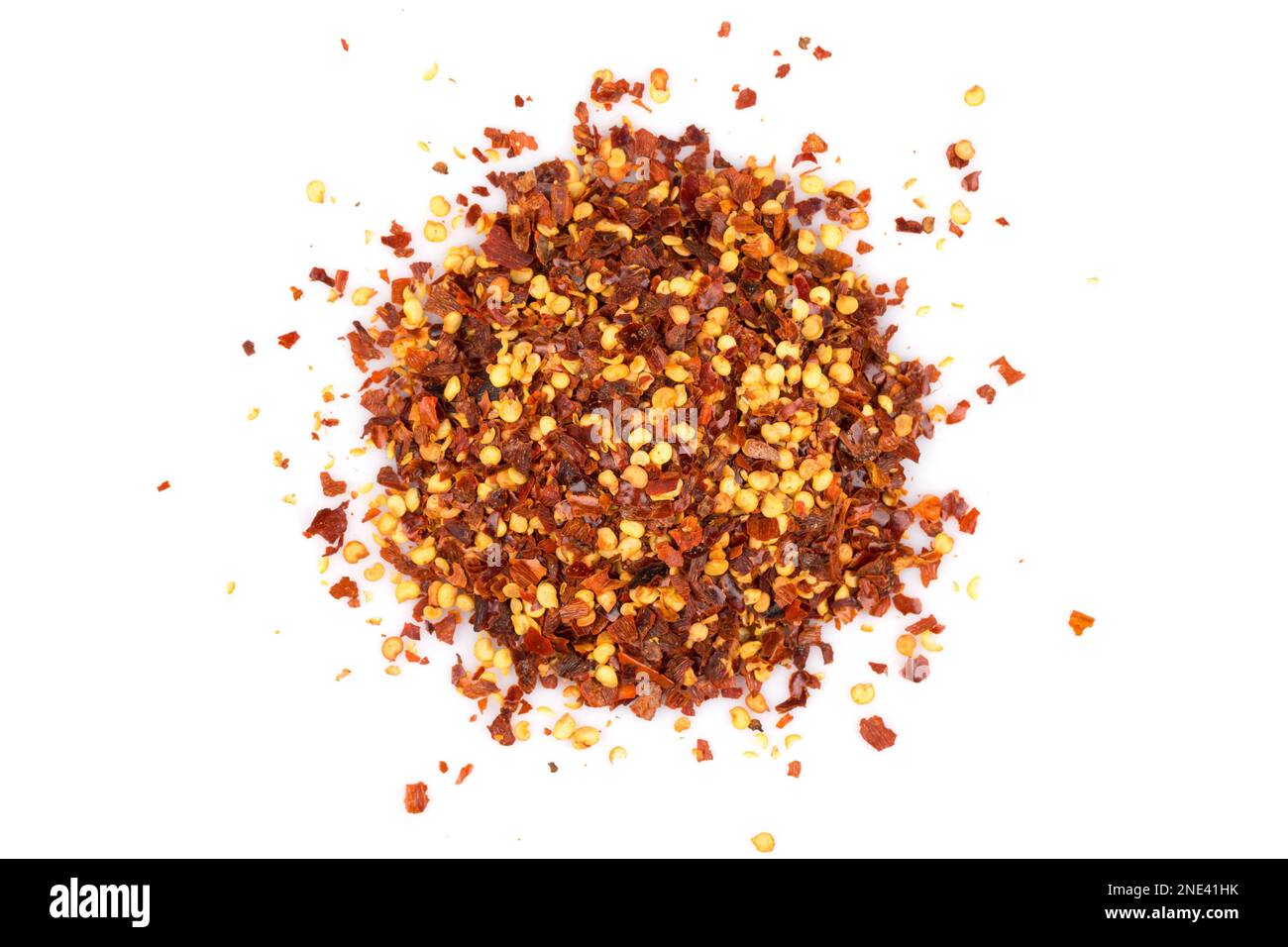 The pile of a crushed red pepper, dried chili flakes and seeds isolated