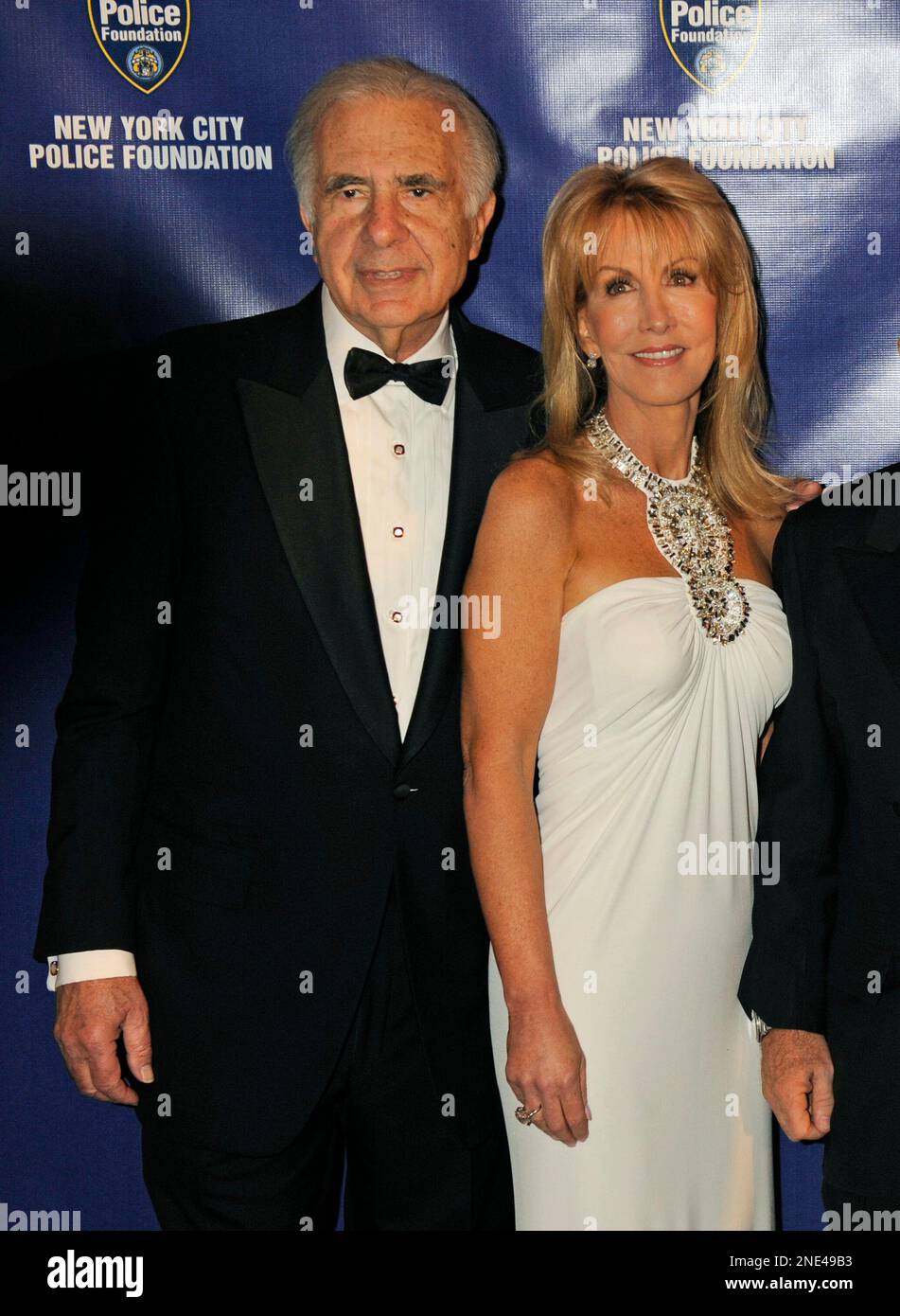 Financier Carl Icahn, left, and his wife, Gail, pose for photos upon arriving for the 32nd
