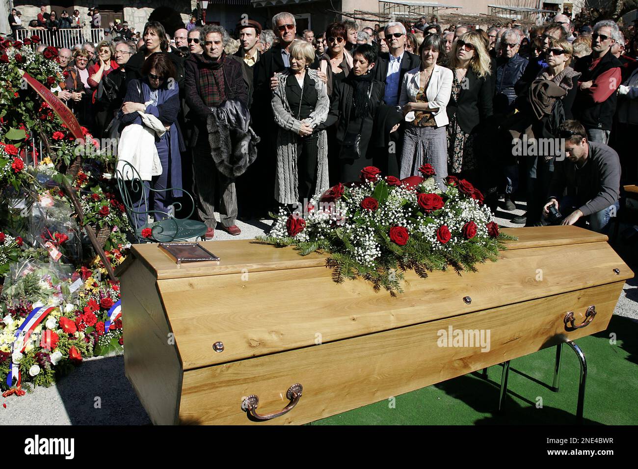 Relatives of French singer Jean Ferrat gather around his coffin in  Entraigues-sur-Volane, southern France, Tuesday March 16, 2010. Ferrat, a  leftist singer and songwriter whose communist convictions with talent for  poetic love