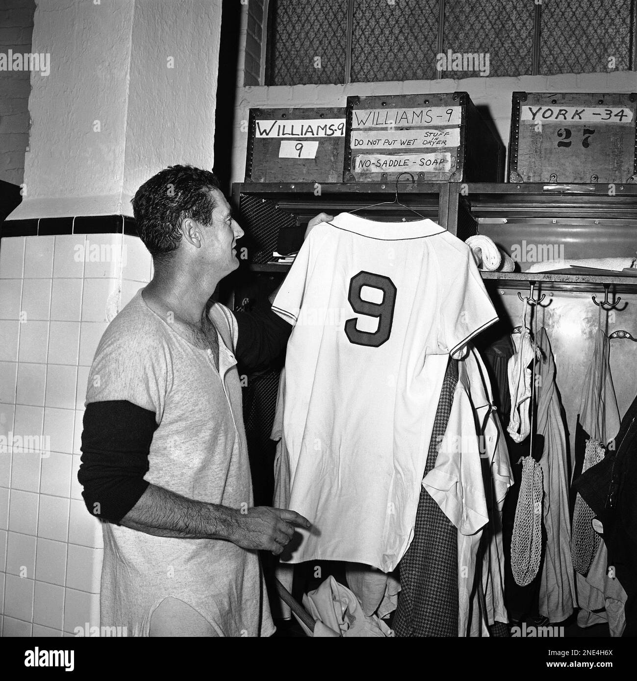 Ted Williams, Boston Red Sox slugger hangs up his shirt for the last time  in the dressing room at Fenway Park in Boston, Sept. 28, 1960, following  his announcement of immediate retirement