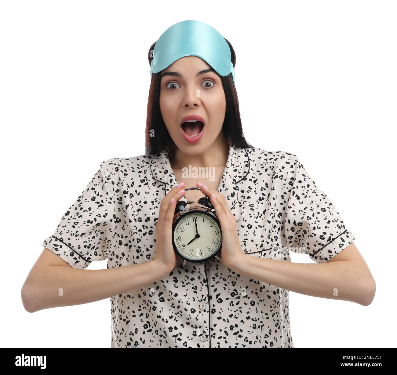 Emotional overslept woman with alarm clock on white background. Being