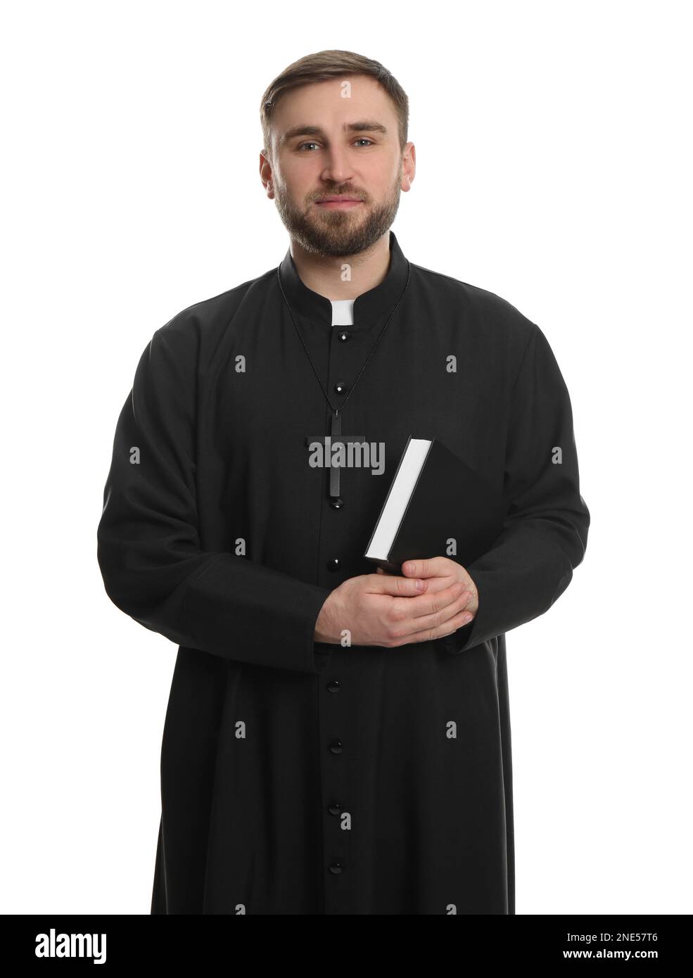 Priest in cassock with Bible on white background Stock Photo