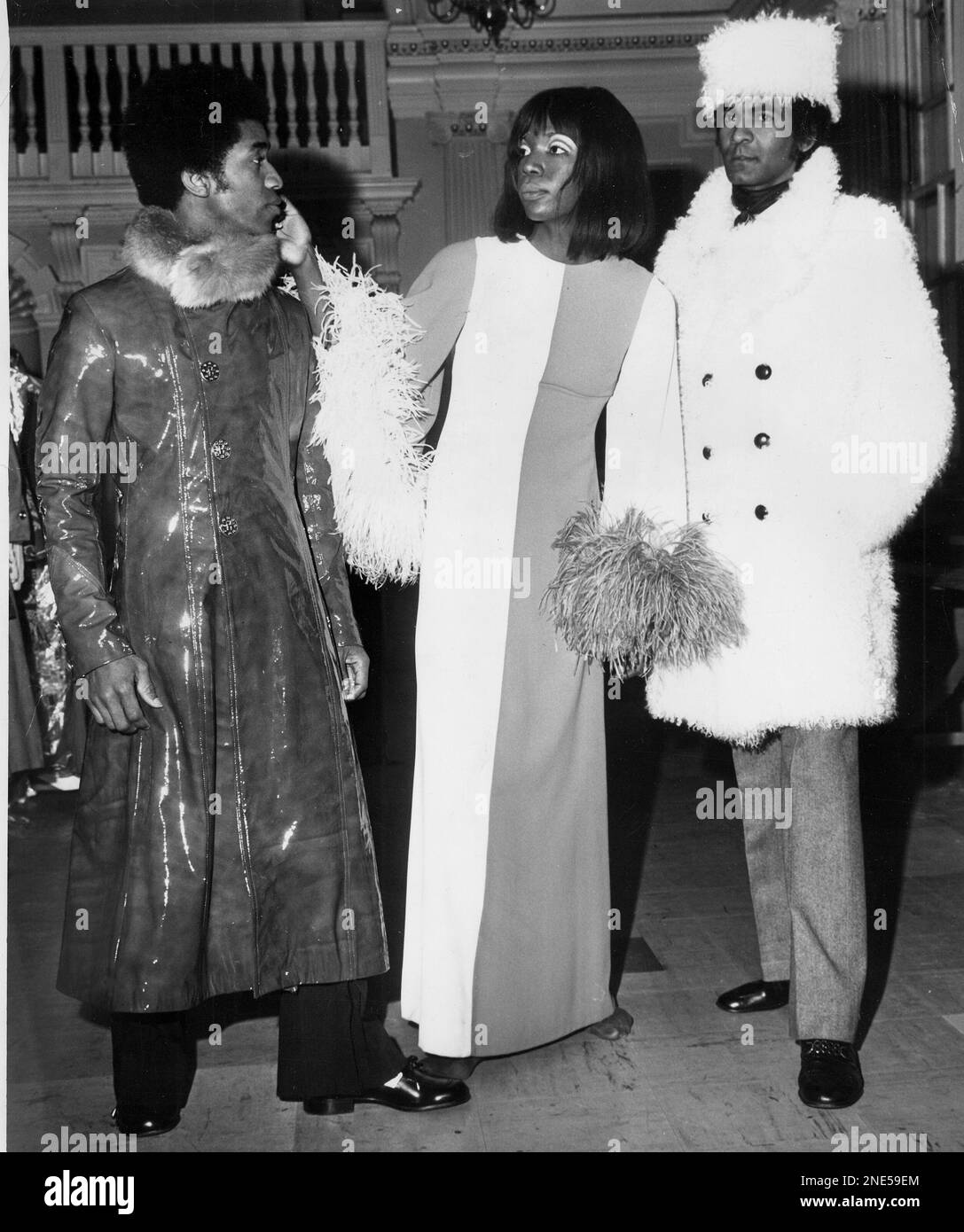 Posing at Chelsea's Town Hall in London are three fashion models ...