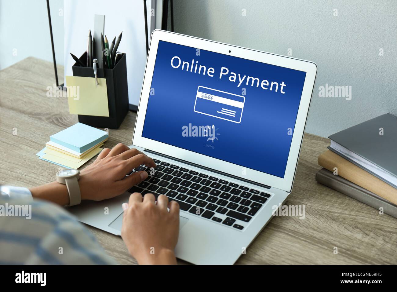 Woman using laptop for online payment at table, closeup Stock Photo