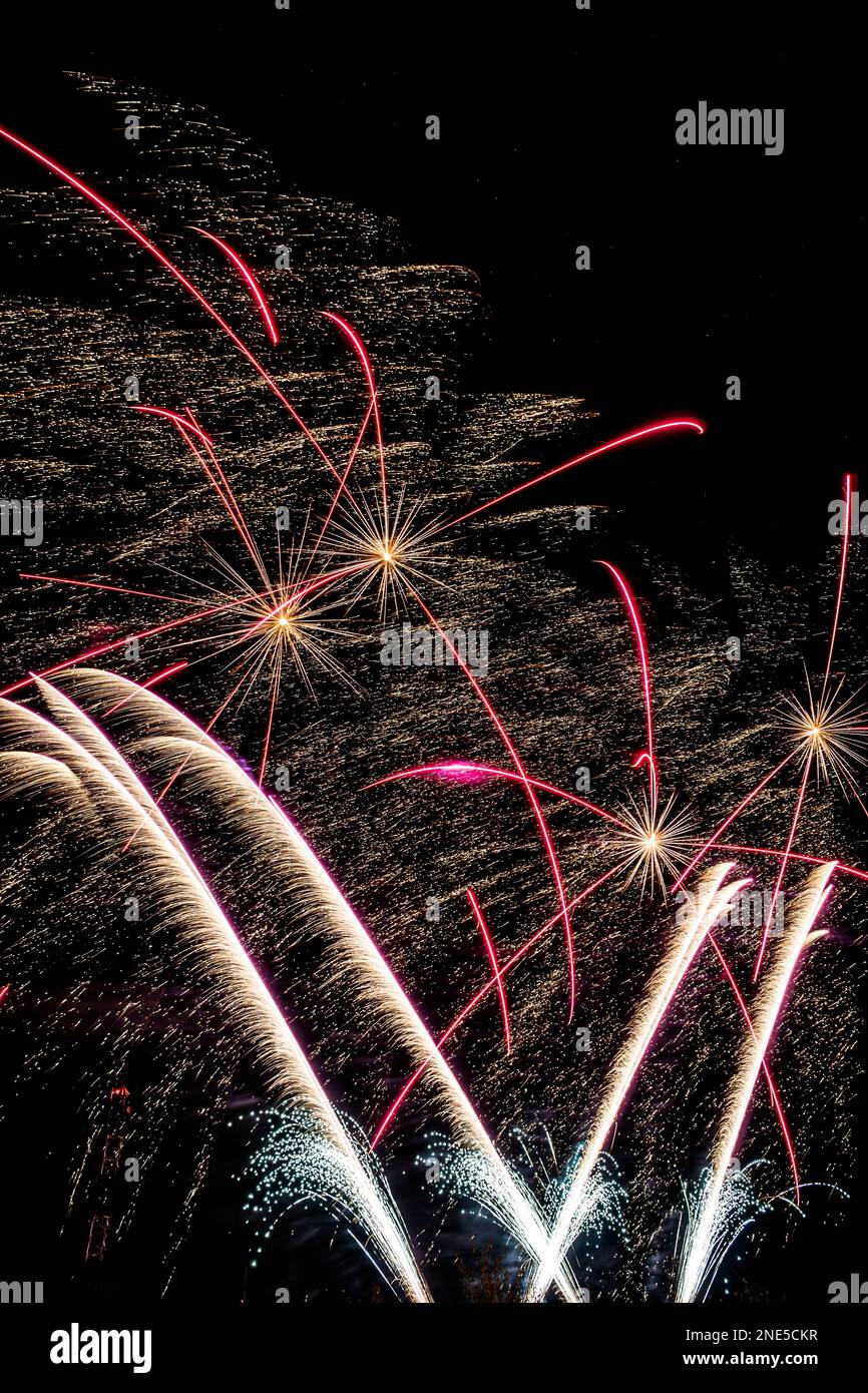 Vertical image of a fireworks display with wind affecting the