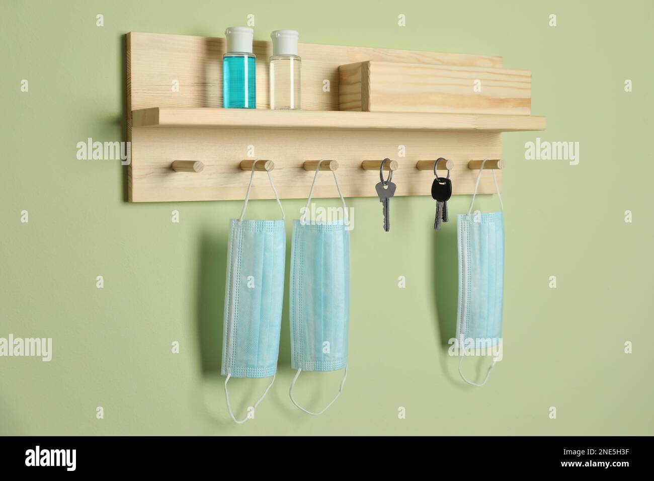 Wooden hanger for keys on light green wall Stock Photo Alamy