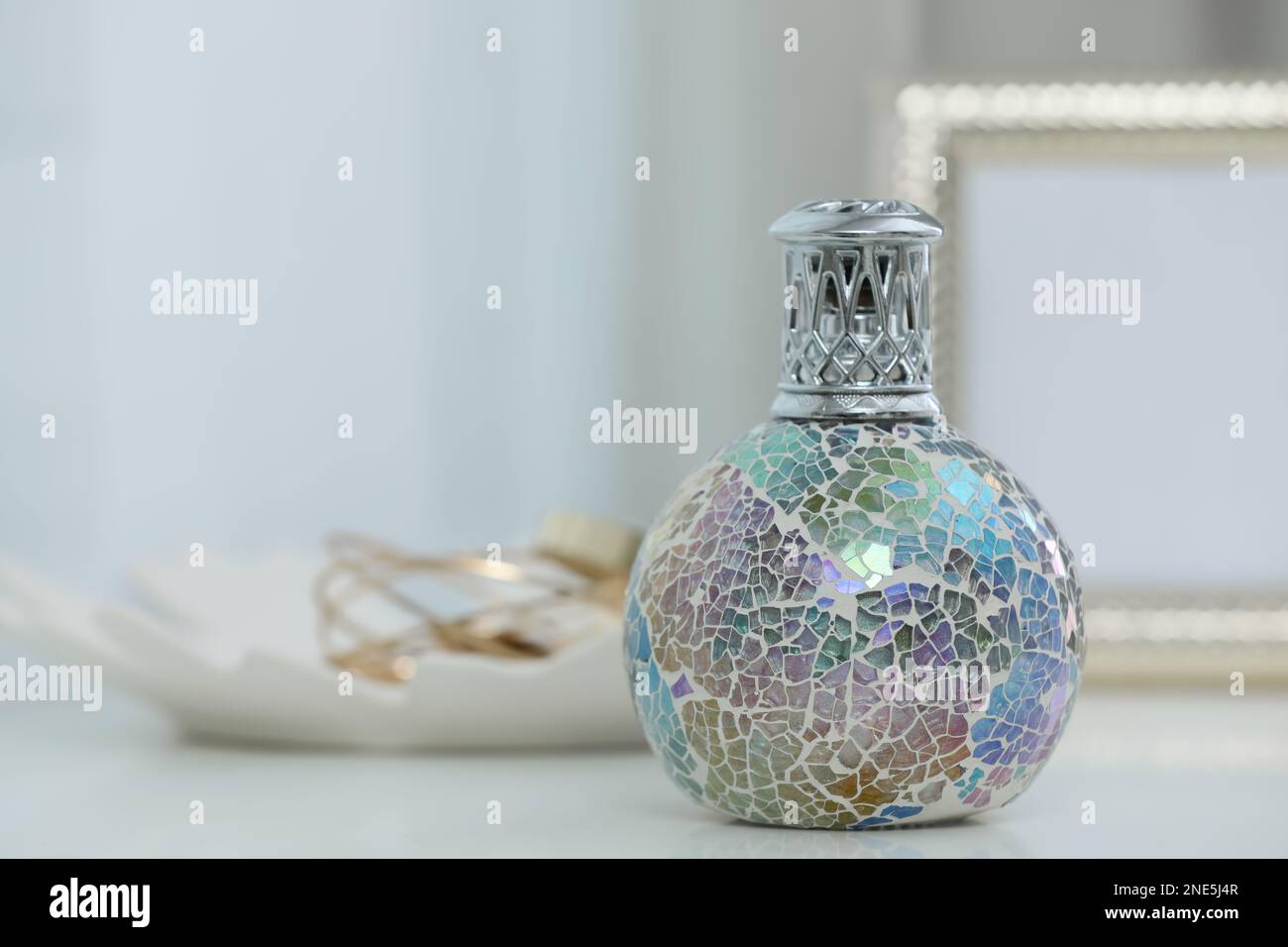 Burning catalytic purifying lamp on table, space for text. Interior ...