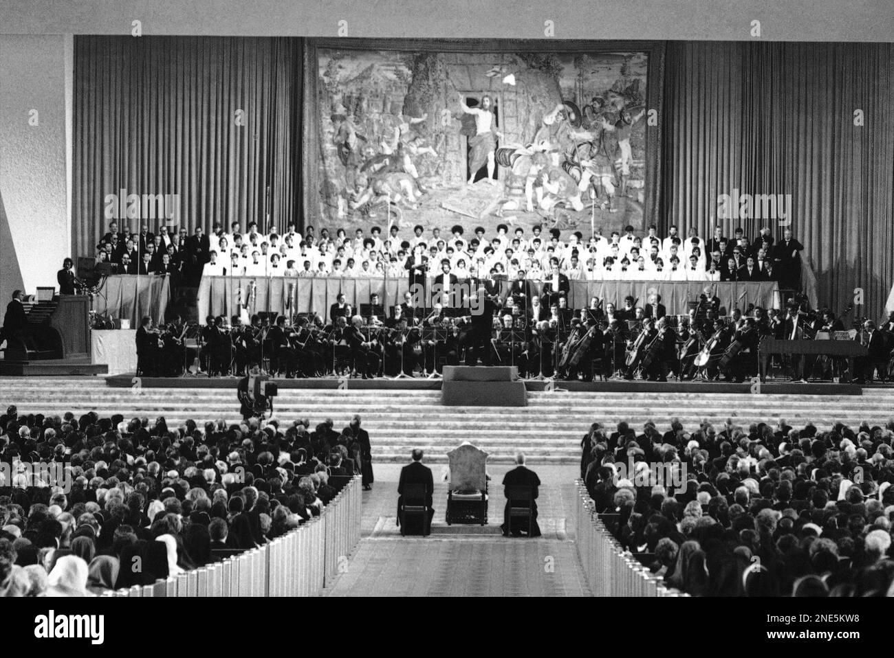 Conductor Leonard Bernstein, left, removes his coat, upper photo, and ...