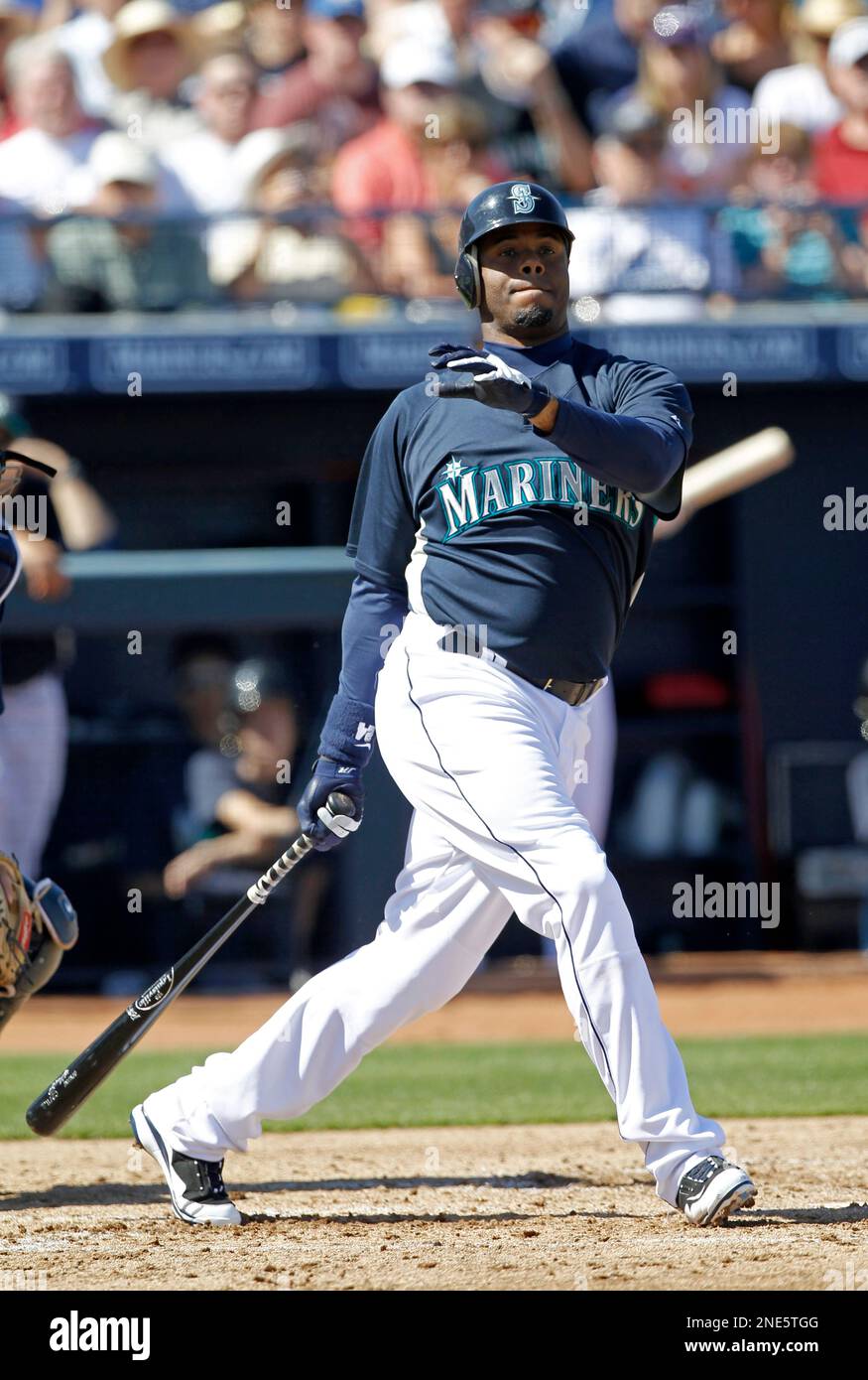 Seattle Mariners right fielder Ken Griffey Jr., left, hugs left fielder  Michael Saunders during a spring training baseball practice Thursday, Feb.  25, 2010, in Peoria, Ariz. (AP Photo/Charlie Neibergall Stock Photo - Alamy