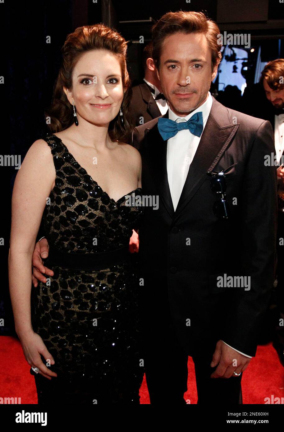 Tina Fey, left, and Robert Downey Jr., right, pose backstage at the