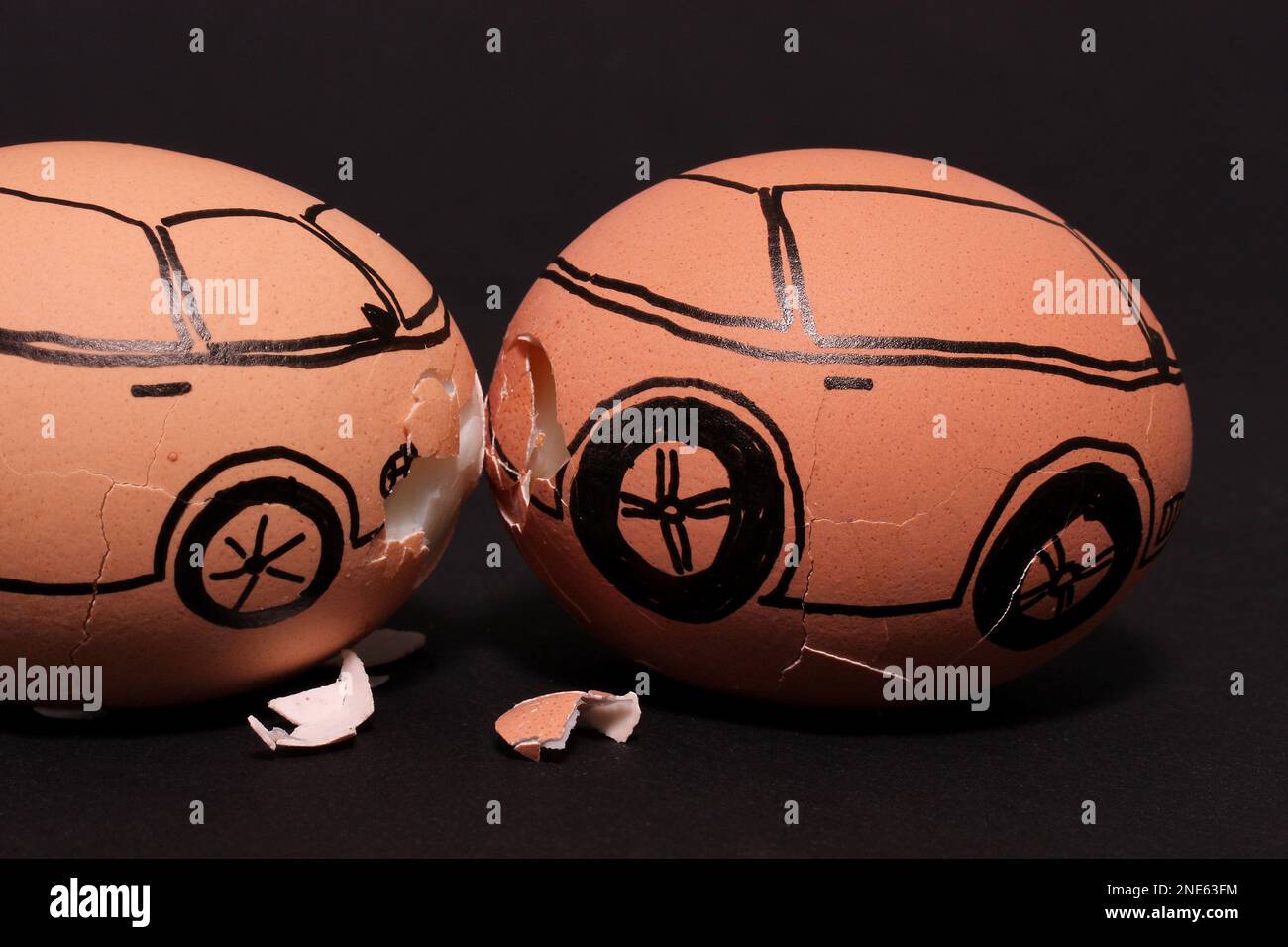 brown chicken eggs painted as cars, car accident Stock Photo Alamy